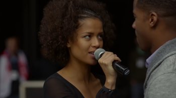 Movie still from “Beyond the Lights” (2014), directed by Gina Prince-Bythewood – A woman holding a microphone up to her mouth; Close Up shot, Over the shoulder angle
