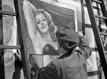 Movie still from “Bicycle Thieves” (1948), directed by Vittorio De Sica – An old photo of a man painting a picture of a woman; Medium shot, Over the shoulder angle