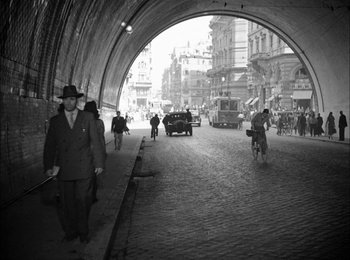 Movie still from “Bicycle Thieves” (1948), directed by Vittorio De Sica – A black and white photo of people walking on a street; Extreme Wide shot, High angle