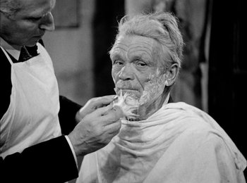 Movie still from “Bicycle Thieves” (1948), directed by Vittorio De Sica – An old man getting his hair cut by a barber; Close Up shot, Over the shoulder angle