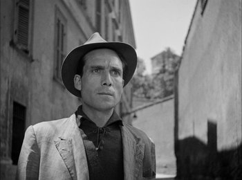 Movie still from “Bicycle Thieves” (1948), directed by Vittorio De Sica – Black and white photograph of a man wearing a hat; Close Up shot, Low angle