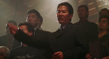 Movie still from “Big Momma's House” (2000), directed by Raja Gosnell – A group of men in suits standing in a room; Medium shot, Low angle