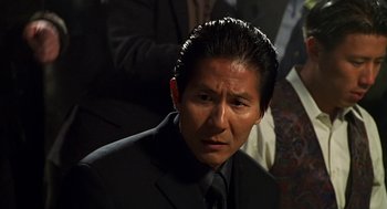 Movie still from “Big Momma's House” (2000), directed by Raja Gosnell – A person wearing a suit and tie; Close Up shot, Over the shoulder angle