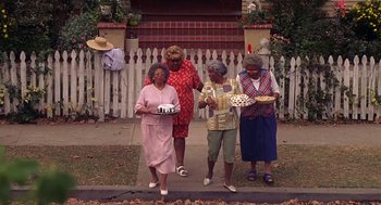 Movie still from “Big Momma's House” (2000), directed by Raja Gosnell – A group of older women standing next to each other holding cakes; Wide shot, High angle
