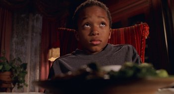 Movie still from “Big Momma's House” (2000), directed by Raja Gosnell – A young boy sitting in a chair looking up at the ceiling; Close Up shot, High angle