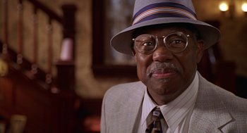 Movie still from “Big Momma's House” (2000), directed by Raja Gosnell – An older man wearing a hat and glasses; Close Up shot, Low angle