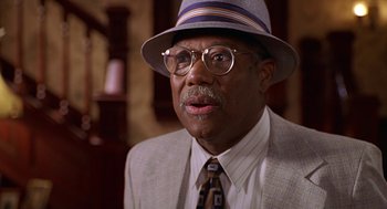 Movie still from “Big Momma's House” (2000), directed by Raja Gosnell – An older man wearing a suit and a hat; Close Up shot, Low angle