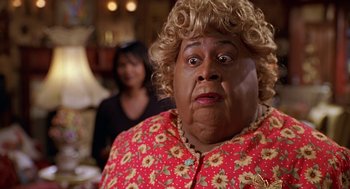 Movie still from “Big Momma's House” (2000), directed by Raja Gosnell – A person wearing a red and yellow dress; Close Up shot, High angle