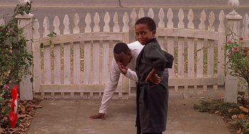 Movie still from “Big Momma's House” (2000), directed by Raja Gosnell – Two young boys playing tug - o - war on a sidewalk; Medium shot, Low angle