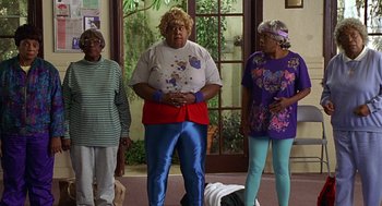 Movie still from “Big Momma's House” (2000), directed by Raja Gosnell – A group of people standing in front of a door; Wide shot, Low angle