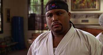 Movie still from “Big Momma's House” (2000), directed by Raja Gosnell – A person wearing a karate uniform; Close Up shot, Low angle