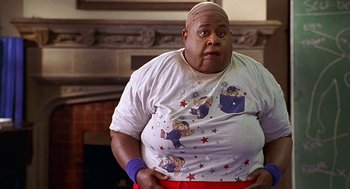 Movie still from “Big Momma's House” (2000), directed by Raja Gosnell – An overweight man wearing a t - shirt with cartoon bears on it; Medium shot, High angle