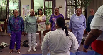 Movie still from “Big Momma's House” (2000), directed by Raja Gosnell – A group of people standing in a room; Medium shot, High angle