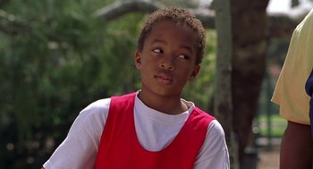 Movie still from “Big Momma's House” (2000), directed by Raja Gosnell – A boy in a red shirt is looking up; Close Up shot, Over the shoulder angle