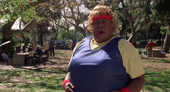 Movie still from “Big Momma's House” (2000), directed by Raja Gosnell – A woman in a blue shirt and a red head band; Close Up shot, Low angle