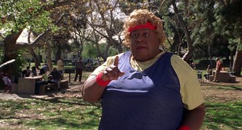 Movie still from “Big Momma's House” (2000), directed by Raja Gosnell – A woman in a yellow shirt and a red headband; Medium shot, Over the shoulder angle