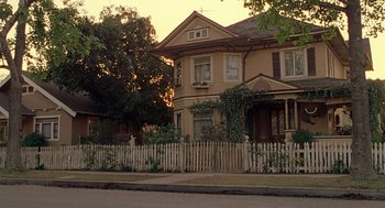 Movie still from “Big Momma's House” (2000), directed by Raja Gosnell – An old house with a white picket fence and trees; Extreme Wide shot, Low angle
