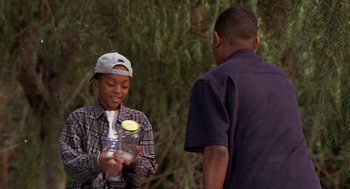 Movie still from “Big Momma's House” (2000), directed by Raja Gosnell – Two young men are holding a jar of fruit; Medium shot, High angle