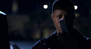 Movie still from “Big Momma's House” (2000), directed by Raja Gosnell – A police officer is holding a cell phone; Close Up shot, Low angle