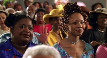 Movie still from “Big Momma's House” (2000), directed by Raja Gosnell – A group of people sitting in a room; Close Up shot, Low angle
