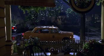 Movie still from “Big Momma's House” (2000), directed by Raja Gosnell – A yellow taxi cab driving down a street; Extreme Wide shot, High angle
