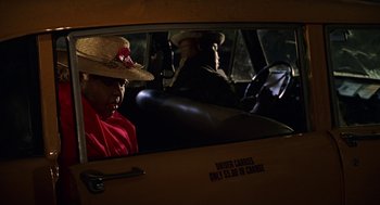 Movie still from “Big Momma's House” (2000), directed by Raja Gosnell – A man wearing a straw hat sitting in the driver's seat of a car; Close Up shot, Low angle