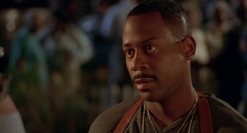 Movie still from “Big Momma's House” (2000), directed by Raja Gosnell – A person wearing a necklace; Close Up shot, Over the shoulder angle