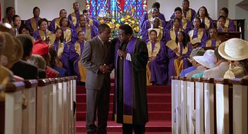 Movie still from “Big Momma's House” (2000), directed by Raja Gosnell – A couple of men standing next to each other in a church; Medium shot, Low angle