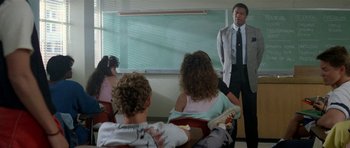 Movie still from “Bill & Ted's Excellent Adventure” (1989), directed by Stephen Herek – A man standing in front of a group of people; Medium shot, Over the shoulder angle