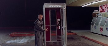 Movie still from “Bill & Ted's Excellent Adventure” (1989), directed by Stephen Herek – A man standing in front of a phone booth at night; Medium shot, Low angle