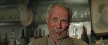 Movie still from “Bill & Ted's Excellent Adventure” (1989), directed by Stephen Herek – An older man with a beard and mustache; Close Up shot, Low angle