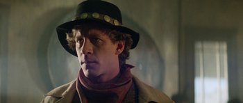 Movie still from “Bill & Ted's Excellent Adventure” (1989), directed by Stephen Herek – A man wearing a black hat and a scarf; Close Up shot, Over the shoulder angle