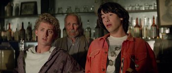 Movie still from “Bill & Ted's Excellent Adventure” (1989), directed by Stephen Herek – A group of people standing next to each other in a room; Medium shot, Over the shoulder angle