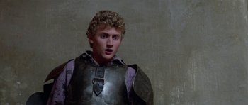 Movie still from “Bill & Ted's Excellent Adventure” (1989), directed by Stephen Herek – A young man wearing a suit of armor; Close Up shot, Low angle