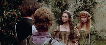 Movie still from “Bill & Ted's Excellent Adventure” (1989), directed by Stephen Herek – A young woman in medieval dress standing next to a young man; Medium shot, Over the shoulder angle