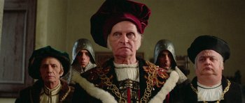 Movie still from “Bill & Ted's Excellent Adventure” (1989), directed by Stephen Herek – A man in a medieval outfit with two other men; Close Up shot, Over the shoulder angle