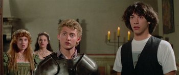Movie still from “Bill & Ted's Excellent Adventure” (1989), directed by Stephen Herek – A young man in a suit of the middle ages; Medium shot, Low angle