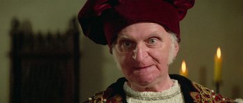 Movie still from “Bill & Ted's Excellent Adventure” (1989), directed by Stephen Herek – An old man with a red hat and a white beard; Close Up shot, Over the shoulder angle