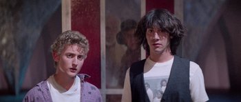 Movie still from “Bill & Ted's Excellent Adventure” (1989), directed by Stephen Herek – A couple of men standing next to each other in a room; Medium shot, Over the shoulder angle
