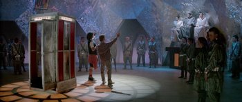 Movie still from “Bill & Ted's Excellent Adventure” (1989), directed by Stephen Herek – A group of people standing around in a room; Wide shot, Over the shoulder angle