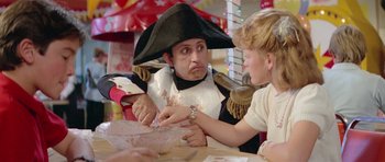 Movie still from “Bill & Ted's Excellent Adventure” (1989), directed by Stephen Herek – A man dressed as a pirate and a girl dressed as a pirate; Medium shot, Over the shoulder angle