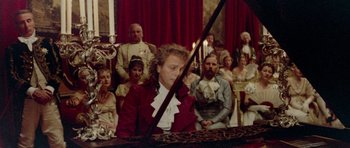 Movie still from “Bill & Ted's Excellent Adventure” (1989), directed by Stephen Herek – A woman in a red jacket is playing the piano; Medium shot, High angle