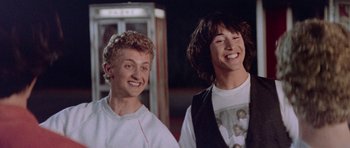 Movie still from “Bill & Ted's Excellent Adventure” (1989), directed by Stephen Herek – A couple of men standing next to each other; Medium shot, Low angle