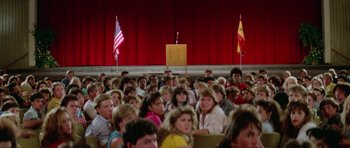 Movie still from “Bill & Ted's Excellent Adventure” (1989), directed by Stephen Herek – A crowd of people sitting in front of a microphone; Wide shot, High angle