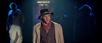 Movie still from “Bill & Ted's Excellent Adventure” (1989), directed by Stephen Herek – A man wearing a hat and a jacket; Medium shot, Over the shoulder angle