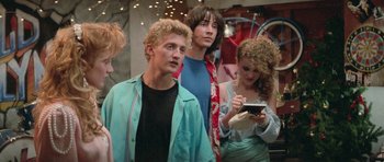 Movie still from “Bill & Ted's Excellent Adventure” (1989), directed by Stephen Herek – A group of young men and women standing next to each other; Medium shot, Over the shoulder angle
