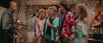 Movie still from “Bill & Ted's Excellent Adventure” (1989), directed by Stephen Herek – A group of people standing next to each other in a room; Medium shot, Over the shoulder angle