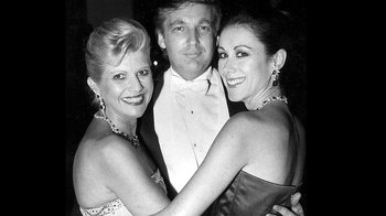 A man and two women posing for a picture