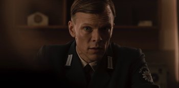 Movie still from “Dark” (2017), created by Baran bo Odar – A person wearing a uniform; Close Up shot, Low angle