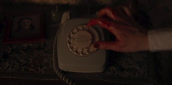 Movie still from “Dark” (2017), created by Baran bo Odar – A woman's hand on a phone on a table; Extreme Close Up shot, High angle